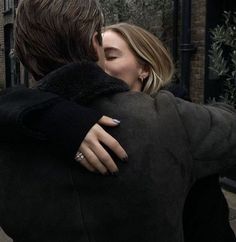 a man and woman embracing each other on the street