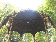 an ornate gazebo in the middle of a park