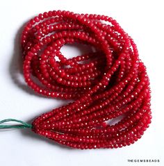 the beads are red and there is a green bead on top of each strand