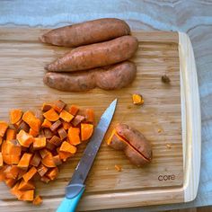 a cutting board with carrots and potatoes on it