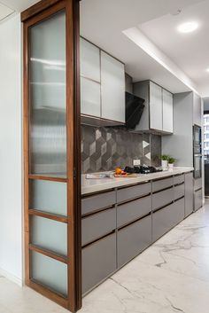 a kitchen with marble counter tops and cabinets