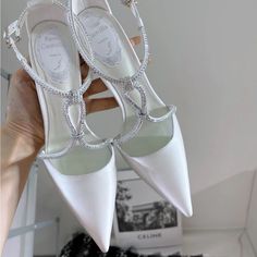 a pair of white high heeled wedding shoes