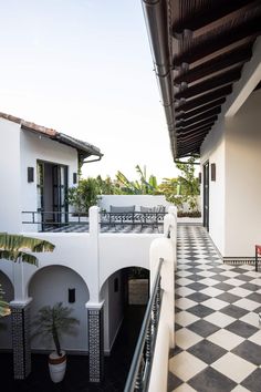 an outdoor patio with black and white checkered flooring