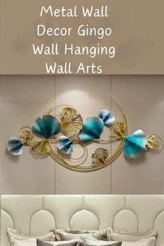 a metal wall decoration with blue flowers and gold leaves on the headboard in a bedroom