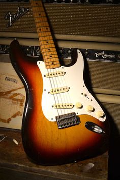 an electric guitar sitting on top of a table