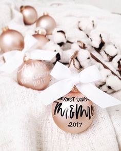 a white and gold ornament sitting on top of cotton