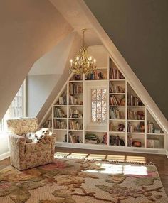 a room with a chair, bookshelf and chandelier