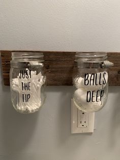 three mason jars are hanging on the wall