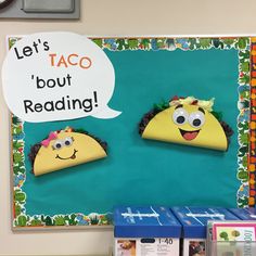 a bulletin board with two tacos and a sign that says let's taco but reading