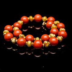 This ethnic-style necklace made of burnt-orange-red chinese 20 mm jasper beads, rate russian rainforest serpentine, and african brass. The reddish veins in the dragon-green of the serpentine match the color of the jade. Beautiful, somewhat subdued, colors of this truly international necklace bring together the visions of swampy forests, red rocks, and desert sands in the red sunset. Red Coral Jewelry With Natural Stones In Round Beads, Spiritual Orange Red Coral Jewelry, Spiritual Orange Jewelry With Red Coral, Red Jasper Spiritual Necklace, Artisan Red Coral Hand-strung Jewelry, Artisan Hand-strung Red Coral Jewelry, Artisan Hand-strung Red Coral Necklace, Unique Red Jasper Jewelry, Unique Red Coral Round Bead Jewelry