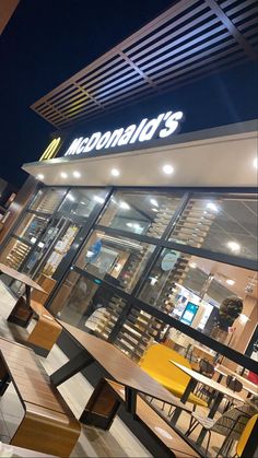 a mcdonald's restaurant is lit up at night