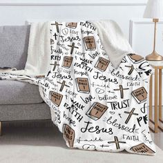 a blanket with the words jesus and bibles on it is sitting in front of a couch