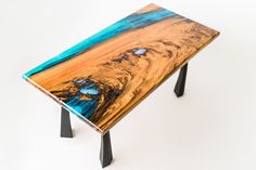 a wooden table with blue and yellow paint on it