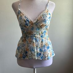 Blue And White Floral Pattern Tank Top By Mine. Brand New With Tags - Never Been Worn. Sleeveless. Adjustable Straps. Elastic Smocked On Backside. V Neckline. Eyelet Trim Around Bust. Size Small. Fitted Blue Floral Print Camisole, Fitted Floral Print Tank Top For Brunch, Blue Summer Style Camisole For Spring, Blue Floral Print Camisole For Spring, Blue Spring Camisole For Day Out, Casual Floral Print Camisole For Daywear, Blue Floral Print Cami Top, Blue Spring Camisole Top, Spring Floral Print Cami Blouse