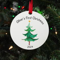 a personalized ornament hanging from a christmas tree