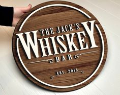 the jack's whiskey bar sign is made from wood and has white lettering on it