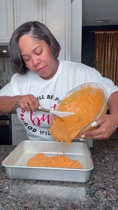 a woman pouring orange sauce into a pan