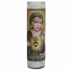 a white candle with an image of a woman on it