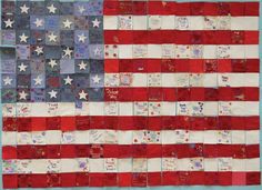 an american flag made out of small pieces of fabric with words written on the side