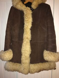 A beautiful American short coat made of sheepskin, covered with sheep fur. Made in U.S.A Size 14 Tag says: San Remo Dimensions: sleeve from collar: 77cm sleeve from armpit: 41cm in the chest: 2x 53cm in waist: 49x2 cm in hips: 2x55cm total length: 81cm Vintage Shearling Fur Coat With Faux Fur Trim, Brown Hooded Fur Coat With Faux Fur Lining, Vintage Sheepskin Fur Coat For Cold Weather, Hooded Brown Sheepskin Fur Coat, Hooded Shearling Coat With Faux Fur Trim, Hooded Shearling Fur Coat With Faux Fur Lining, Hooded Shearling Fur Coat With Faux Fur Trim, Hooded Fur Coat With Faux Fur Lining, Hooded Sheepskin Fur Coat With Faux Fur Trim