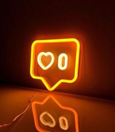 a neon sign that says i love you in the shape of a speech bubble on a dark background