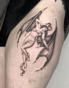 a woman's thigh with a tattoo on it