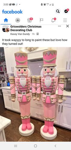 two pink and gold nutcrackers standing next to each other in the kitchen