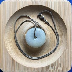 This Ping An Kou jade pendant symbolizes peace, completeness, and harmony. It is meant to bring peace and good fortune to the wearer, keeping them safe from misfortune and expressing wishes for a fulfilling life, successful career, and harmonious family. It also conveys a sense of understated elegance. 100% natural, untreated, and undyed. It's handmade with natural materials. Each piece is unique, so expect slight variations in size, color, and shape. Jade pendants have been loved since ancient Jade Amulet Necklace With Round Pendant, Round Jade Spiritual Necklaces, Spiritual Round Jade Necklaces, Spiritual Round Jade Necklace, Jade Round Pendant Necklace For Healing, Round Jade Necklace For Spiritual Style, Jade Amulet Jewelry With Round Pendant, Spiritual Jade Medallion Necklace, Spiritual Jade Round Pendant Necklace