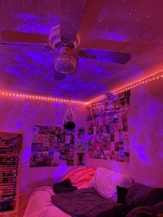 a bedroom with purple lights and pictures on the wall