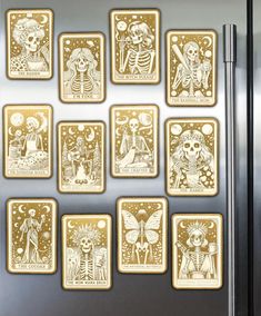 a refrigerator that has some skeleton magnets on the side of it and is decorated with gold foil