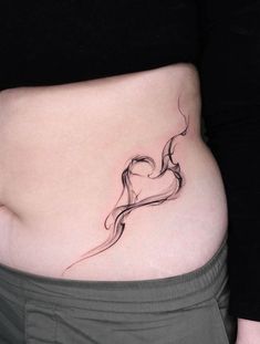 a woman's stomach with a small tattoo on her lower belly and the side