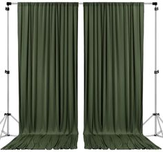 two green curtains with metal poles on them