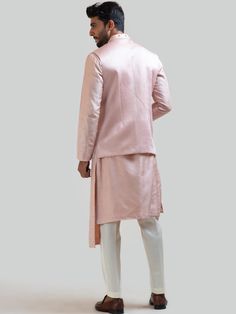 This Onion Pink Mirror Nehru Kurta Set will instantly give an elegant look. This 3 piece kurta set features an onion pink bam silk kurta with box pleat detail on high and low panels with butti embroidery & front buttons, linen satin Nehru jacket with mirror-work, inspired by the toran designs of Rajasthan, invisible front button placket, and a mandarin collar. It is paired with narrow fitted pajama pants in cream color and malai cotton fabric. An ideal outfit for traditional occasions, and speci Elegant Cotton Silk Bandhgala For Diwali, Silk Sherwani Straight Kurta For Formal Occasions, Elegant Cotton Silk Kurta For Formal Occasions, Elegant Cotton Silk Nehru Jacket, Elegant Semi-formal Straight Kurta Set, Elegant Fitted Bandhgala In Cotton Silk, Elegant Fitted Cotton Silk Bandhgala, Elegant Semi-formal Set With Straight Kurta, Elegant Festive Straight Kurta Nehru Jacket