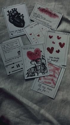 several cards with drawings and hearts on them