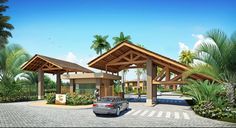 a car is parked in front of a covered parking lot with palm trees around it