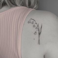 the back of a woman's shoulder with flowers on it