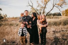 a family posing for a photo in a field