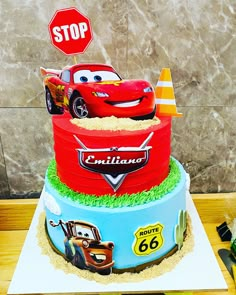 a birthday cake with cars on it and a stop sign