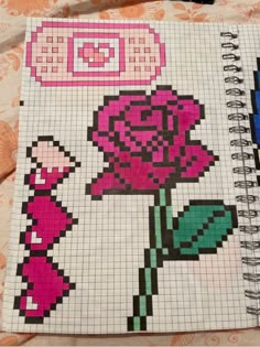 a cross stitch notebook with an image of a pink rose