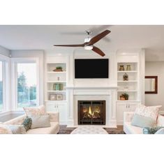 a living room filled with furniture and a fire place in front of a flat screen tv