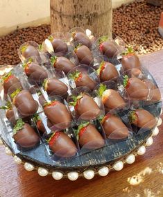 chocolate covered strawberries are arranged on a platter