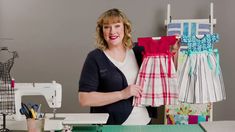 a woman standing in front of a sewing machine