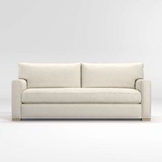 a white couch sitting on top of a white floor