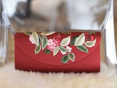 a red envelope decorated with flowers and leaves