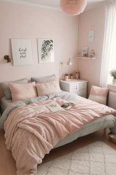 a bedroom with pink walls and bedding in the corner, two pictures on the wall