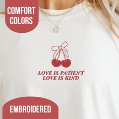 Hi friends, check out our Embroidered Christian Comfort Colors t-shirt! This Bible Verse tshirt is more than just apparel - it's a conversation starter that can share the joy and comfort of Jesus with everyone you meet. It has a delicate coquette style that's effortlessly charming and flattering, making it a staple in your wardrobe. This feminine Christian tshirt was inspired by the Bible verse, 1 Corinthians 13:4 that says, "Love is patient, love is kind. It does not envy, it does not boast, it is not proud." Whether you're lounging at home, strolling through town, or gathering with friends, our Christian Comfort Colors t-shirt is your faithful companion, spreading love, comfort, and the message of Jesus wherever you go. So, slip into something cozy, feminine, and full of faith - and let Casual Embroidered Graphic T-shirt As Gift, Casual Embroidered Text T-shirt As Gift, Casual T-shirt With Embroidered Text As Gift, Casual T-shirt With Embroidered Text For Gift, Christian Comfort, Cherry Shirt, Christian Tshirts Women, Womens Christian Shirts, Love Is Patient Love Is Kind