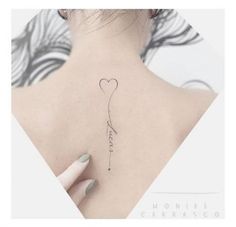 the back of a woman's neck with a heart shaped balloon tattoo on it