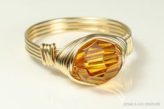 Gold Topaz Crystal Ring Handmade by Jessica Luu Jewelry  ~ Modern ~ Sparkling ~ Glamorous ~ A faceted, round crystal is wrapped by hand with 14K gold filled wire in a solitaire ring that is hand crafted just for you. Topaz is November's birthstone making this a thoughtful birthday gift for someone special. MATCHING ITEMS https://www.etsy.com/shop/JessicaLuuJewelry?search_query=orange+topaz DETAILS: ~ 8mm topaz crystal from Austria ~ 14K yellow or rose gold filled wire HOW IT'S MADE: Each ring is Dainty Yellow Gold Wire Wrapped Rings, Adjustable Gold Wire Wrapped Rings, Minimalist Wire Wrapped Yellow Gold Ring, Yellow Wire Wrapped Round Bead Jewelry, 14k Gold Wire-wrapped Rings, Right Hand Ring, Topaz Crystal, Gold Topaz, Orange Crystals