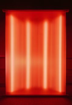 an image of a red light in the middle of a room with vertical lines on it