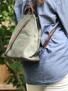 Fabulous small leather backpack - great hands free bag.  Made in Florence Italy as denoted by the stamp on the front (“Genuine Leather Made in Italy”). Inside and outside small zip wall pockets. Anti-theft with the zip closure. Gorgeous color combinations like this grey brown.  #italianleatherbag #italianleatherhandbags #fashionbackpack #travelcarryon #pursesandbags #leatherhandbags #womenbackpack #mensfashion #leatherhandbags Functional Leather Backpack With Cell Phone Pocket For Everyday, Versatile Leather Backpack With Cell Phone Pocket, Trendy Leather Backpack With Cell Phone Pocket, Versatile Leather Backpack With Cell Phone Pocket For Everyday, Everyday Rectangular Leather Backpack With Cell Phone Pocket, Leather Travel Backpack With Cell Phone Pocket, Modern Leather Backpack With Cell Phone Pocket For Travel, Modern Leather Travel Backpack With Cell Phone Pocket, Versatile Brown Backpack With Cell Phone Pocket